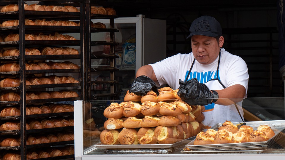 Ecuadorian Baker Displaying Sweet-Rolls